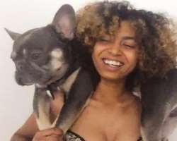 Phoenix is accompanied by a dog in her home.